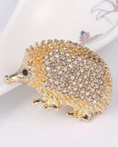 Creative hedgehog brooch in gold tone, cute animal pin with textured details, zinc alloy fashion accessory for adding whimsy to outfits.