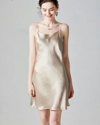 Women’s silk camisole slip dress in nude, sleeveless with spaghetti straps, mini length for summer.
